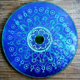 Upcycled CD hand-painted mandala using a blue and purple gradient.