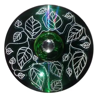 Upcycled CD hand-painted leaf outlines on a smooth dark green background.