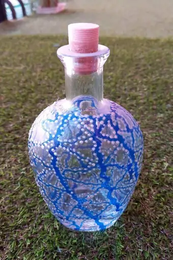 Upcycled clear decanter, hand-painted with a blue and white venial pattern.